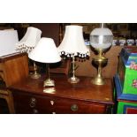 Three various brass table lamps; and a brass oil l