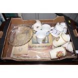 A box of various commemorative items and mugs