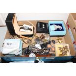 A box containing various wrist watches, brooches,