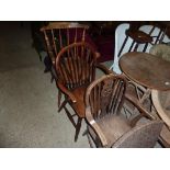 Two elm seated elbow chairs; and a stick back chai