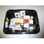 A tray of badges, coins etc.