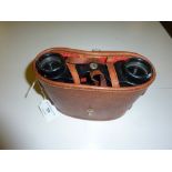 A pair of Lumier binoculars in leather carrying ca