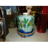 A Majolica style floral decorated cheese dish and