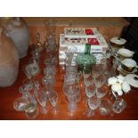 A large quantity of various drinking glasses, vase