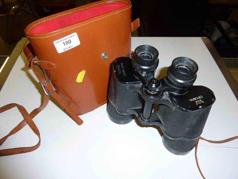 A pair of Crown binoculars in leather carrying cas