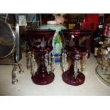 A pair of Victorian ruby glass lustres hung with p