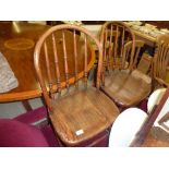 A pair of elm seated stick back chairs