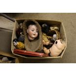 A box containing various dolls and parts