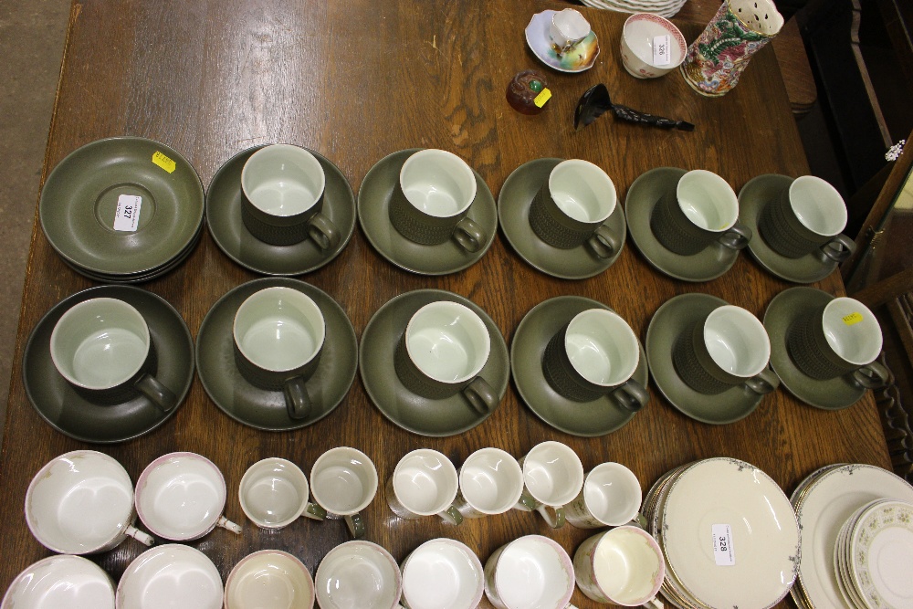 A quantity of Denby teacups and saucers