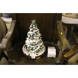 A Thomas Kinkade illuminated Christmas tree