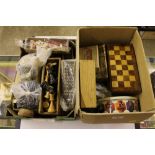 Two boxes containing various games, chess set, dom