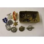 A box containing an African Star War medal; various badges e