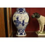 A Delft blue and white vase decorated with boats a