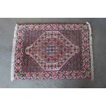 An approx. 3' x 4' red patterned rug