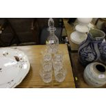 A Royal Doulton cut glass decanter with a set of s