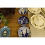 Four blue and white plates decorated with boats an