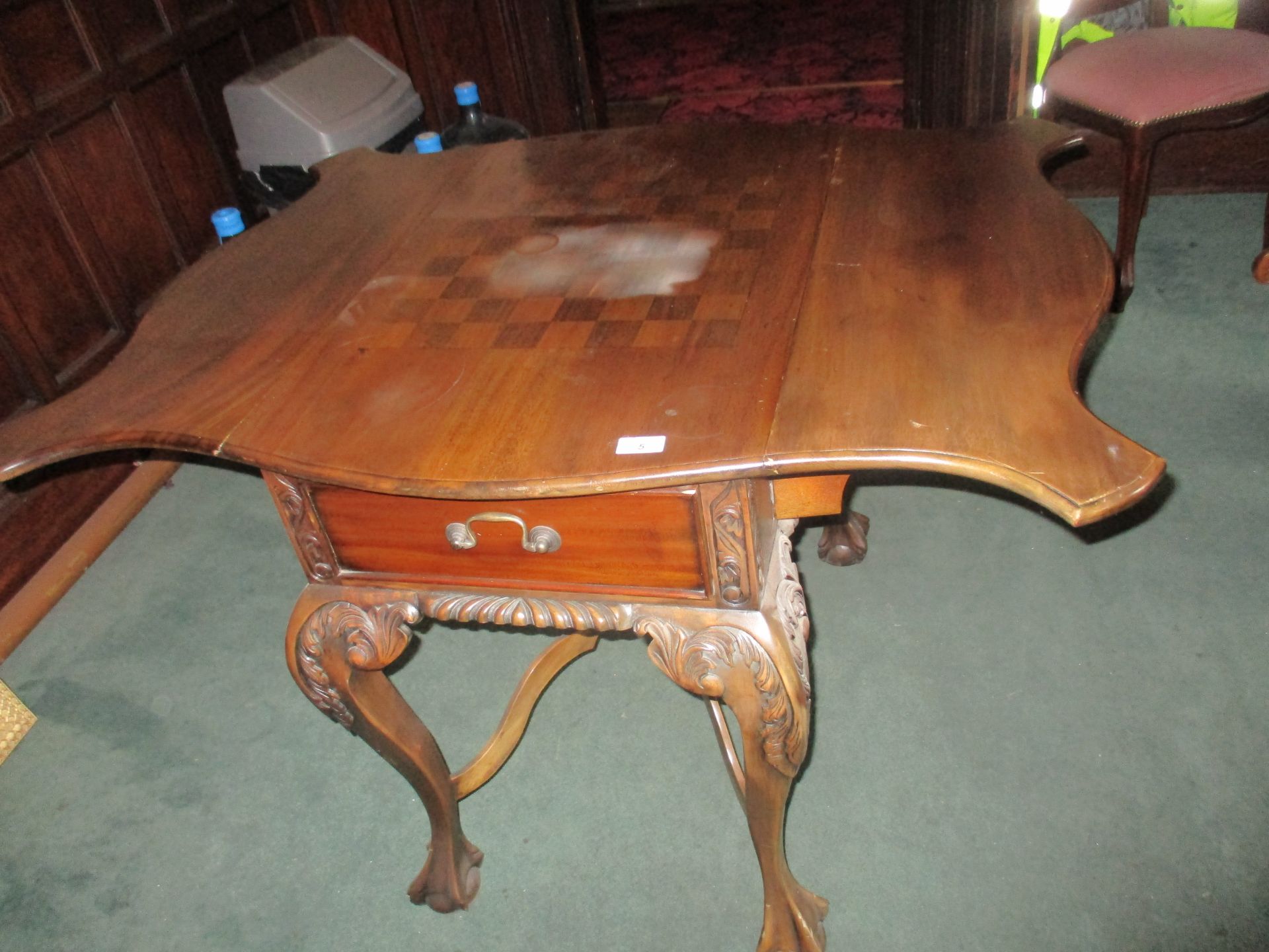 Mahogany drop leaf chess table with two drawers and on cabriole legs and claw and ball feet,