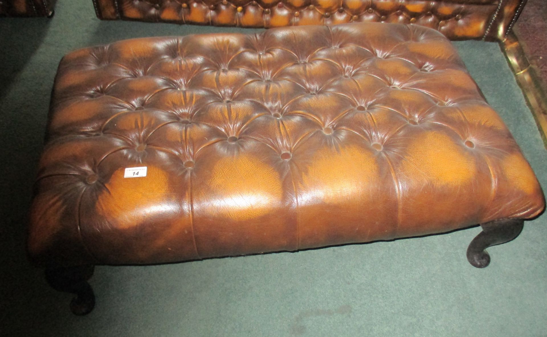 Brown leather deep buttoned footstool.