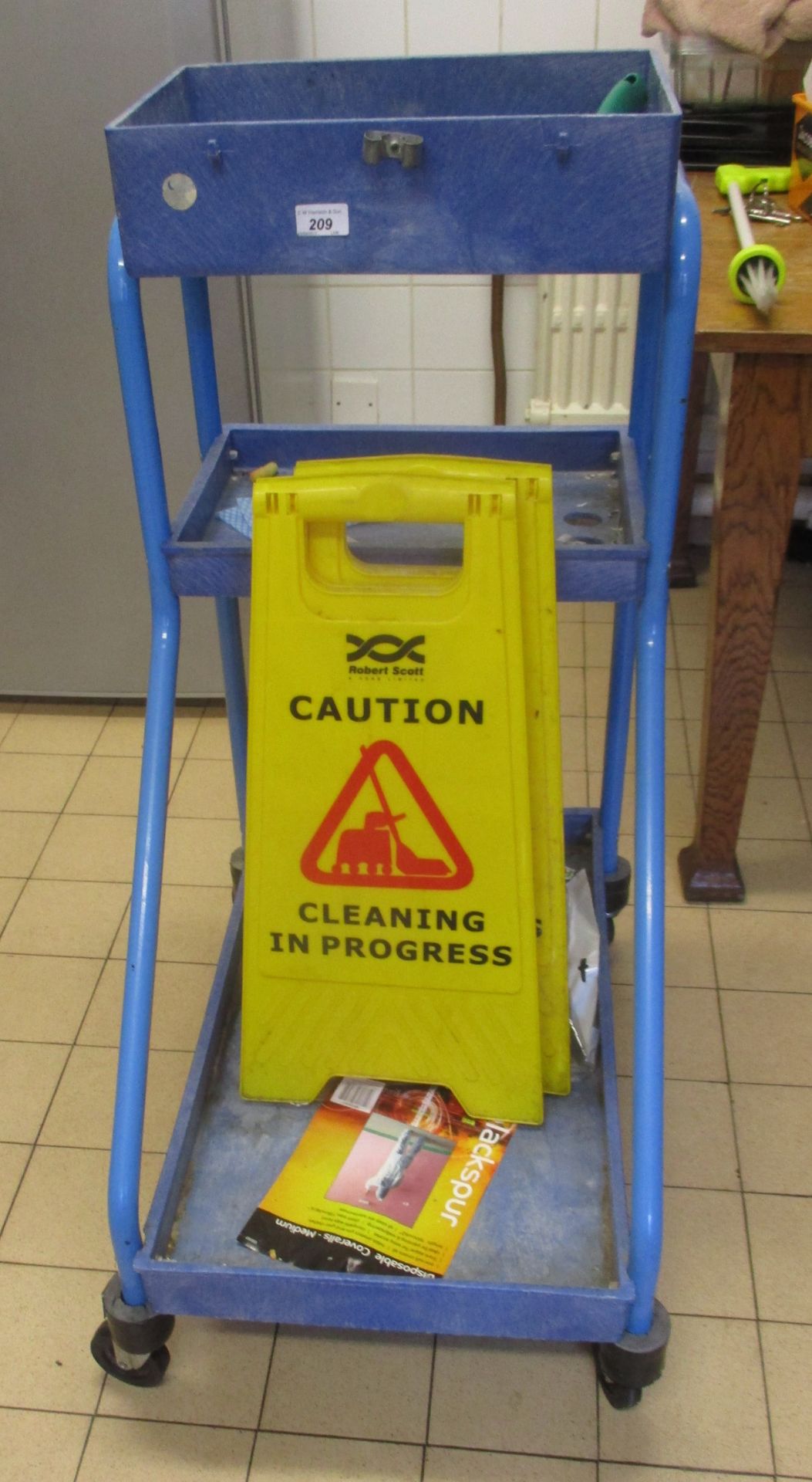 Cleaners blue metal trolley and two safety signs [3].