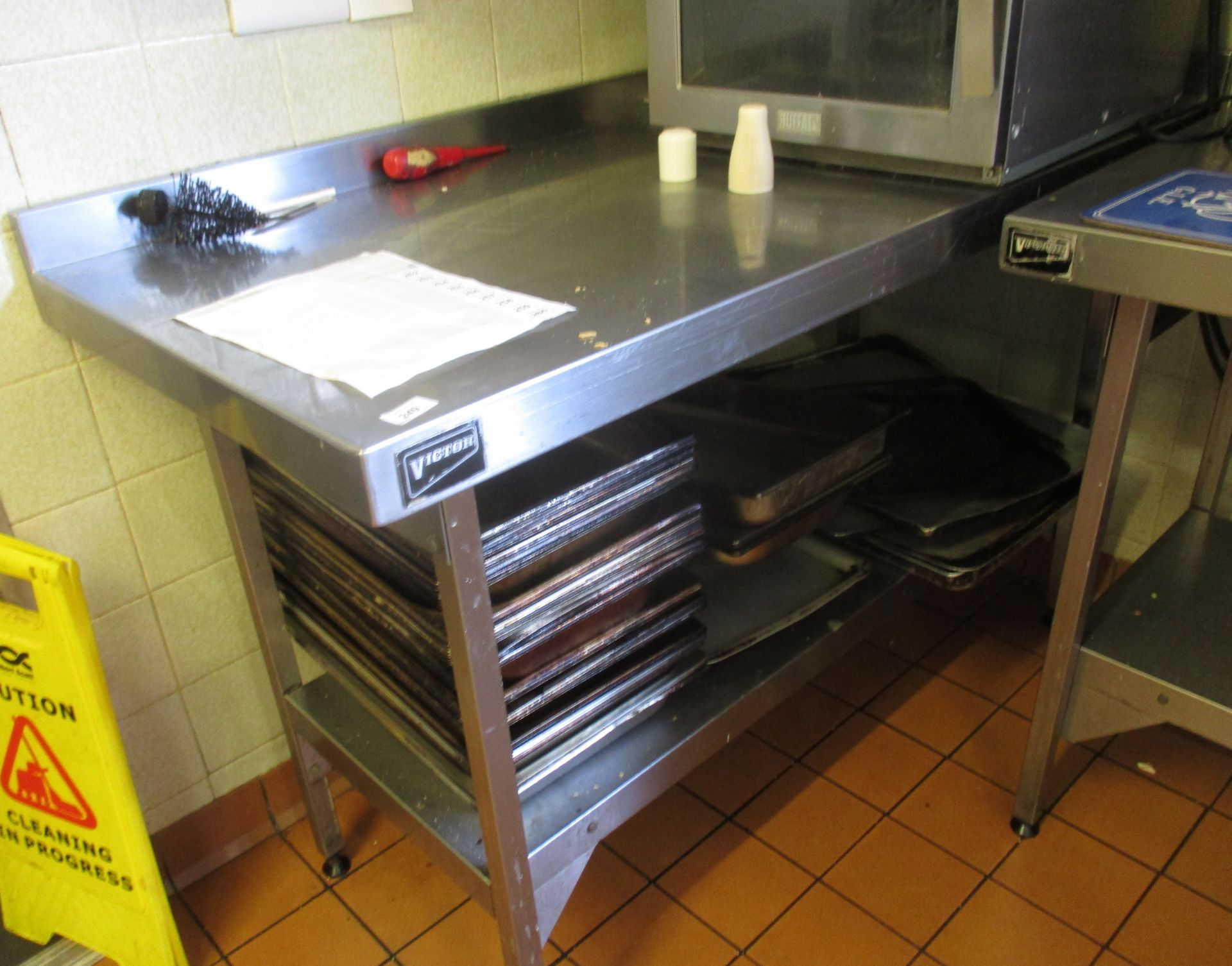 A Victor stainless steel two tier preparation table 140 x 66cm.