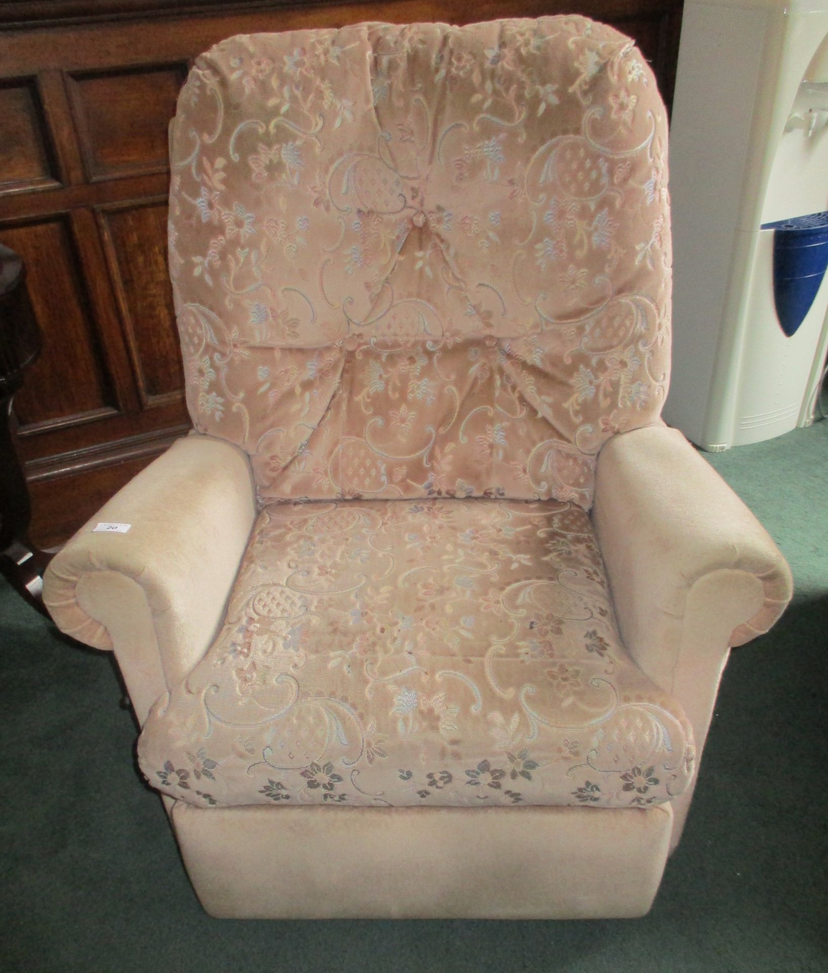 Light pink patterned recliner armchair.