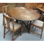 A circular oak drop leaf dining table 120cm (extended),