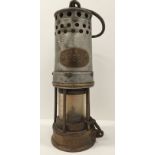A brass and metal miners lamp no 298 stamped to base 1833 27cm high