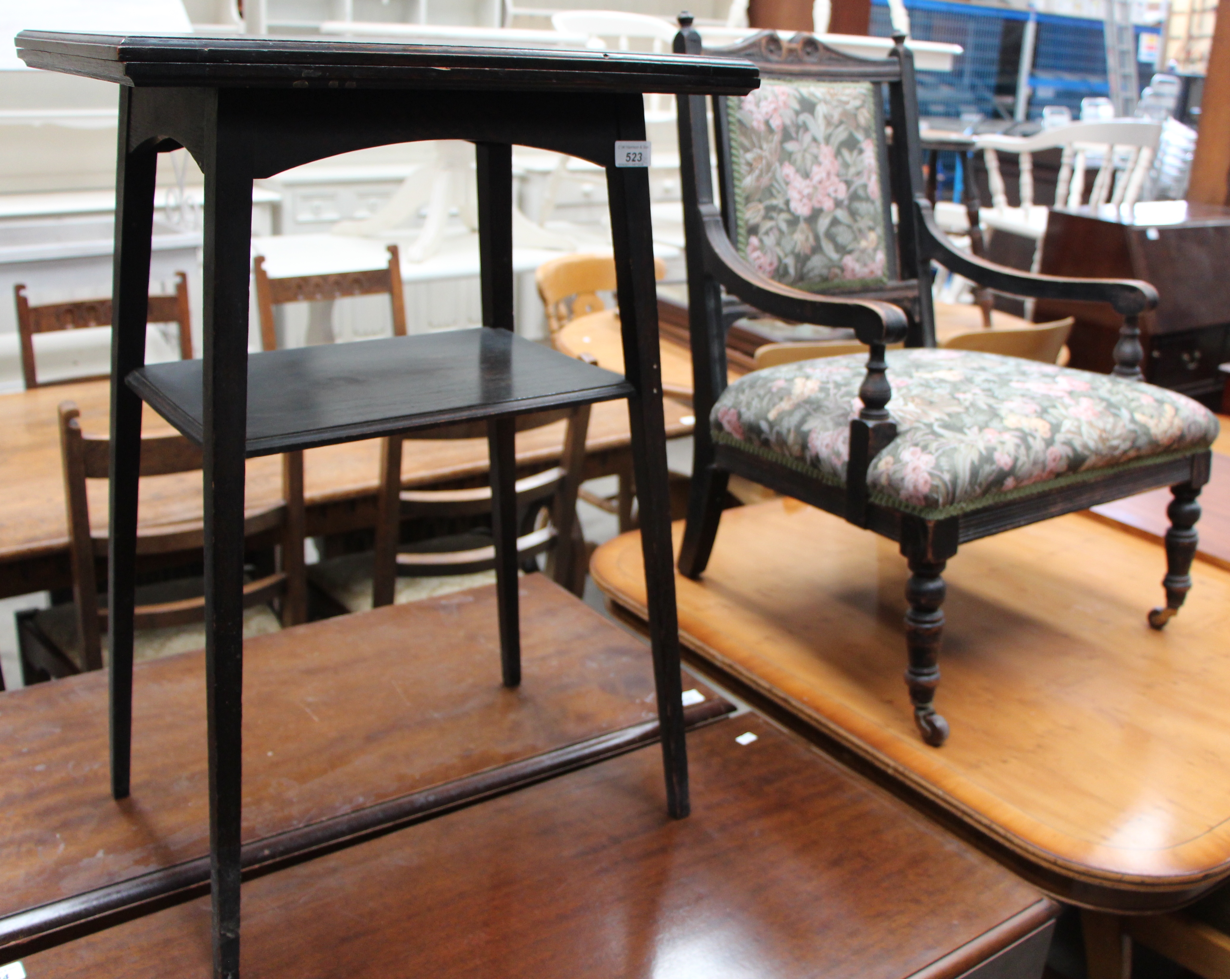 A small oak swivel top card table and an oak framed nursing chair with floral patterned upholstery
