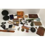 An interesting collection of small artefact's including Ronson Penguin lighter, small vesta case,