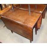 A mahogany drop leaf dining table