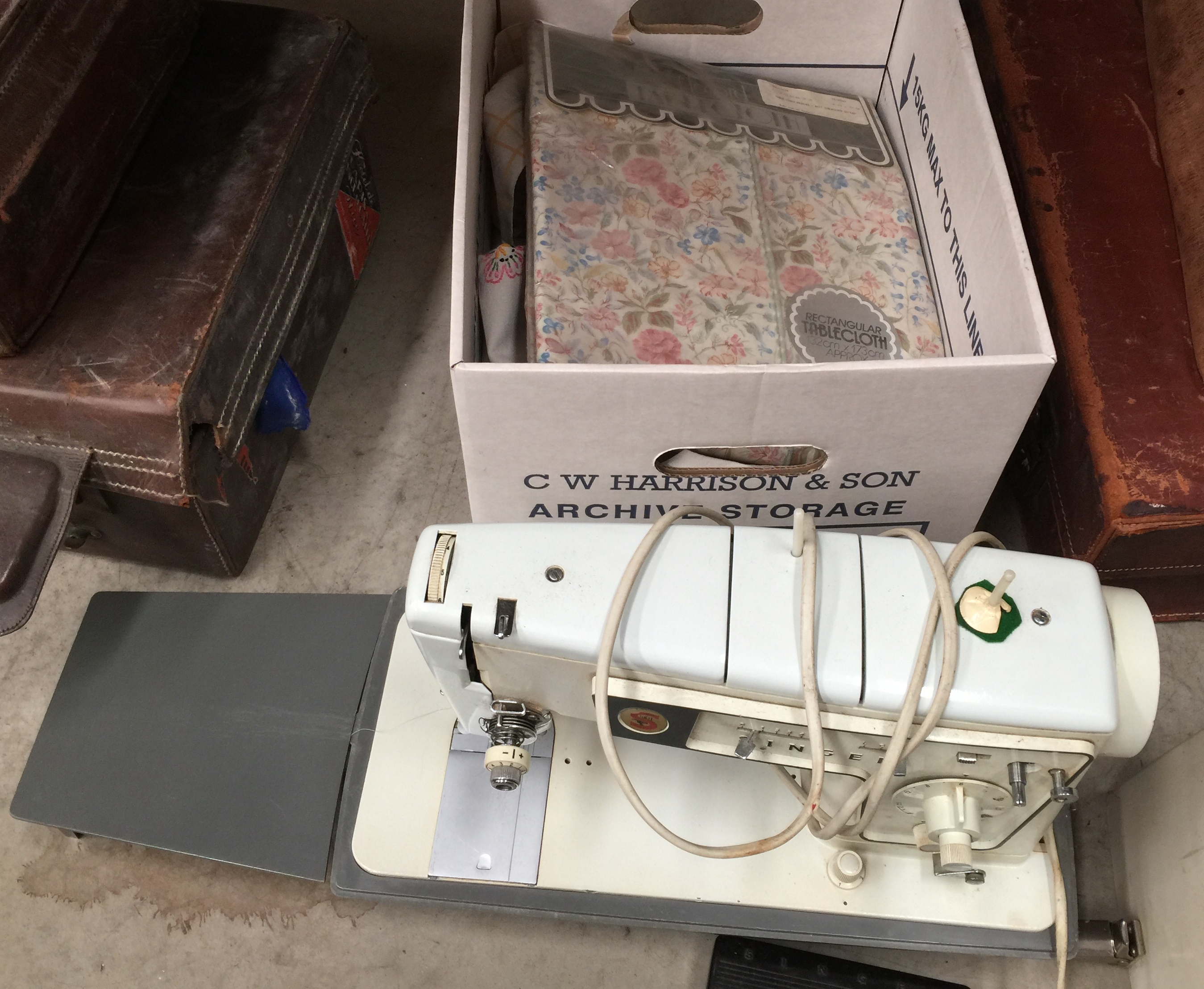 Singer portable electric sewing machine together with box and contents - table linens etc.