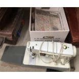 Singer portable electric sewing machine together with box and contents - table linens etc.