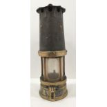 A brass and metal miners lamp stamped 193 24cm high
