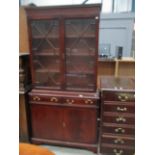 Mahogany reproduction bookcase/wall unit with double astragal glazed door bookcase over 2 drawer,