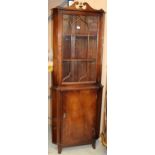 A mahogany freestanding corner with astrgal glazed upper door over lower door 63 x 186cm high