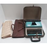 A Lilliput portable typewriter and a brown leather effect sheet music bag (2)