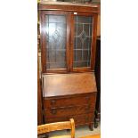 An oak bureau book with glazed doors over fall flap and three drawers 76cm x 188cm high