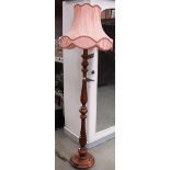 A mahogany standard lamp with shade