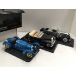 3 x unboxed diecast model motorcars on plinths - 1:18 scale - an Anson Cadillac Sport Phaeton