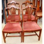 A set of four Hepplewhite style mahogany dining chairs with serpentine top rail and pierced splats,