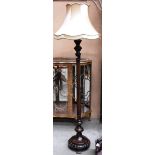 A mahogany standard lamp with shade