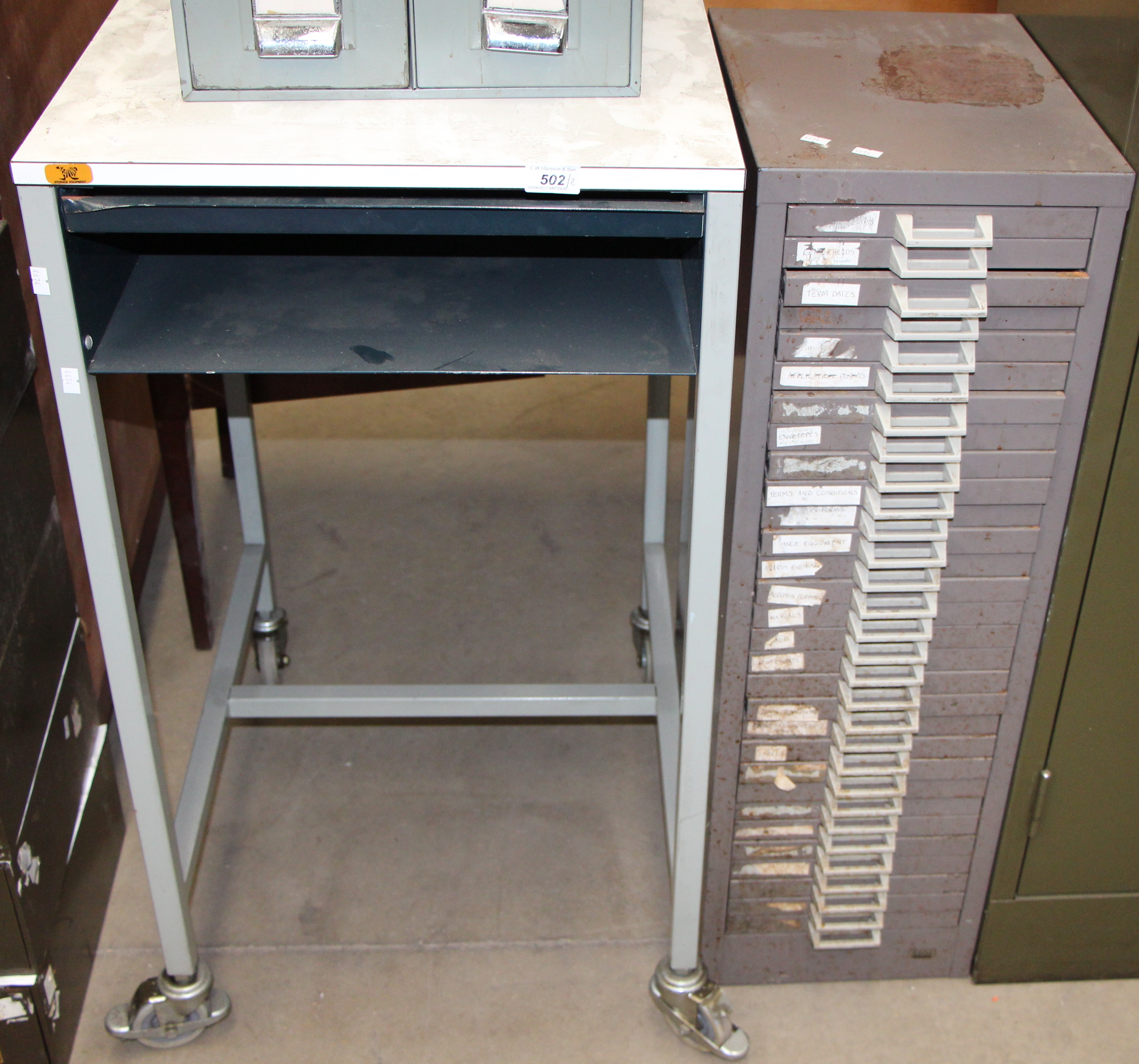 A brown metal 30 drawer freestanding index cabinet and a grey metal framed mobile copier stand (2)