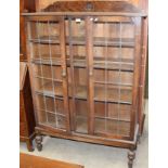 An oak 2 door bookcase (1 door damaged) 109cm x 163cm high