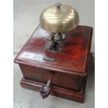 An electrically operated signalling bell in wooden case