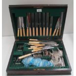 An oak cased composite canteen of mainly stainless steel cutlery