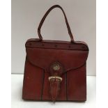 Box and contents including large brown leather handbag together with other assorted bags.