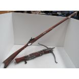 A reproduction musket and a reproduction cross bow