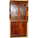 A mahogany reproduction bookcase/wall unit with double astrgal glazed doors over 2 drawer 2 door