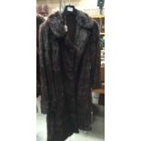 Full length dark brown fur coat.