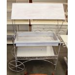 A white painted metal and wood framed display cart